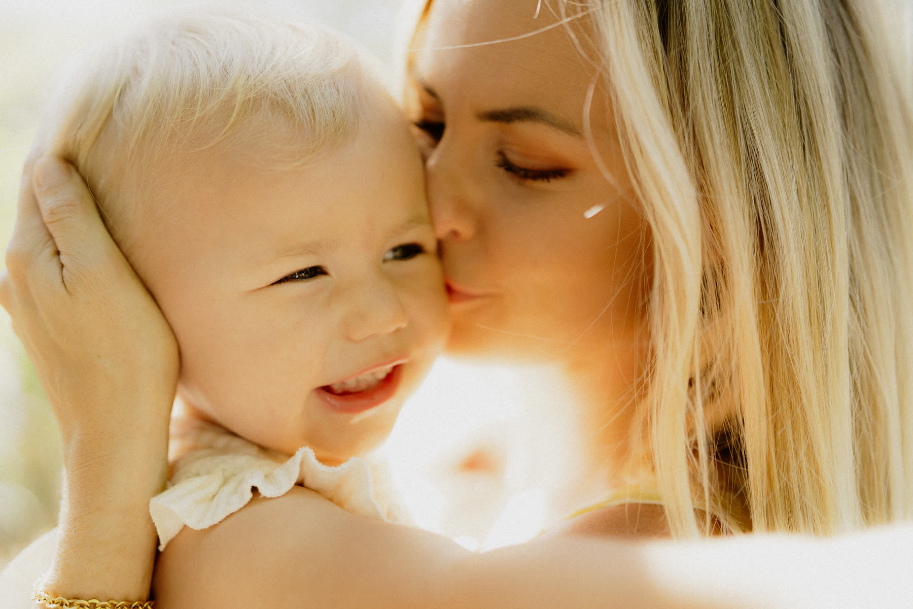A mother breathing in her child
