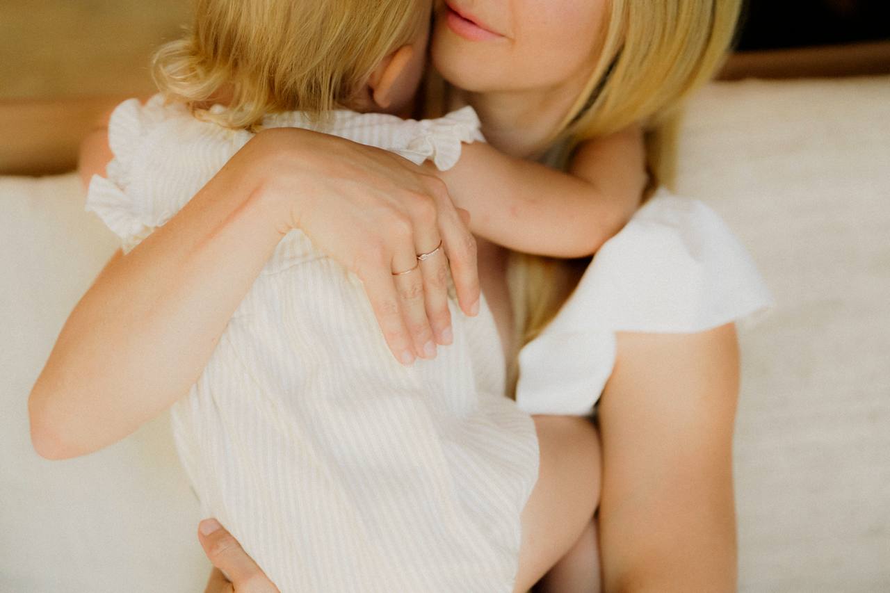 A mother holding her child close